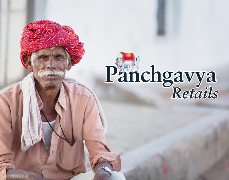 Elderly rural Indian farmer wearing a red turban and light brown shirt, symbolizing the connection to traditional farming. The image features the Panchgavya Retails logo, representing its support for rural farmers and promotion of organic, natural products.