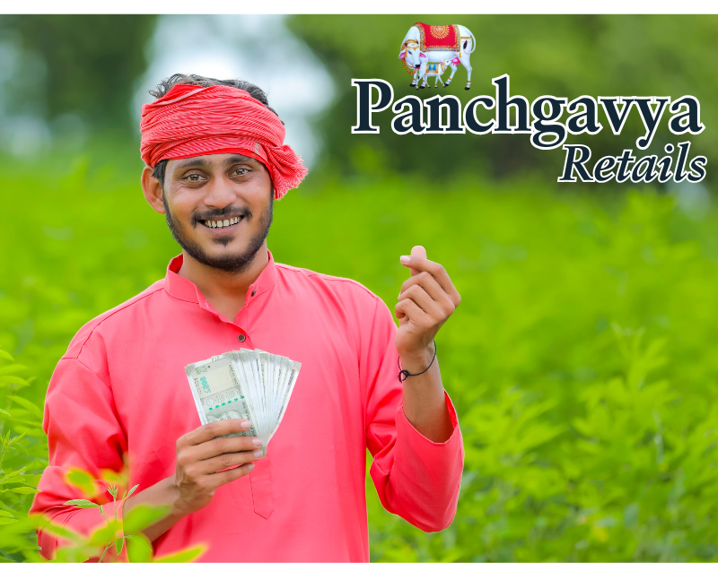 Smiling rural Indian farmer in a green field, wearing a red turban and holding Indian currency notes, symbolizing prosperity. The Panchgavya Retails logo is displayed, representing the empowerment of farmers through direct-to-customer sales of organic products.